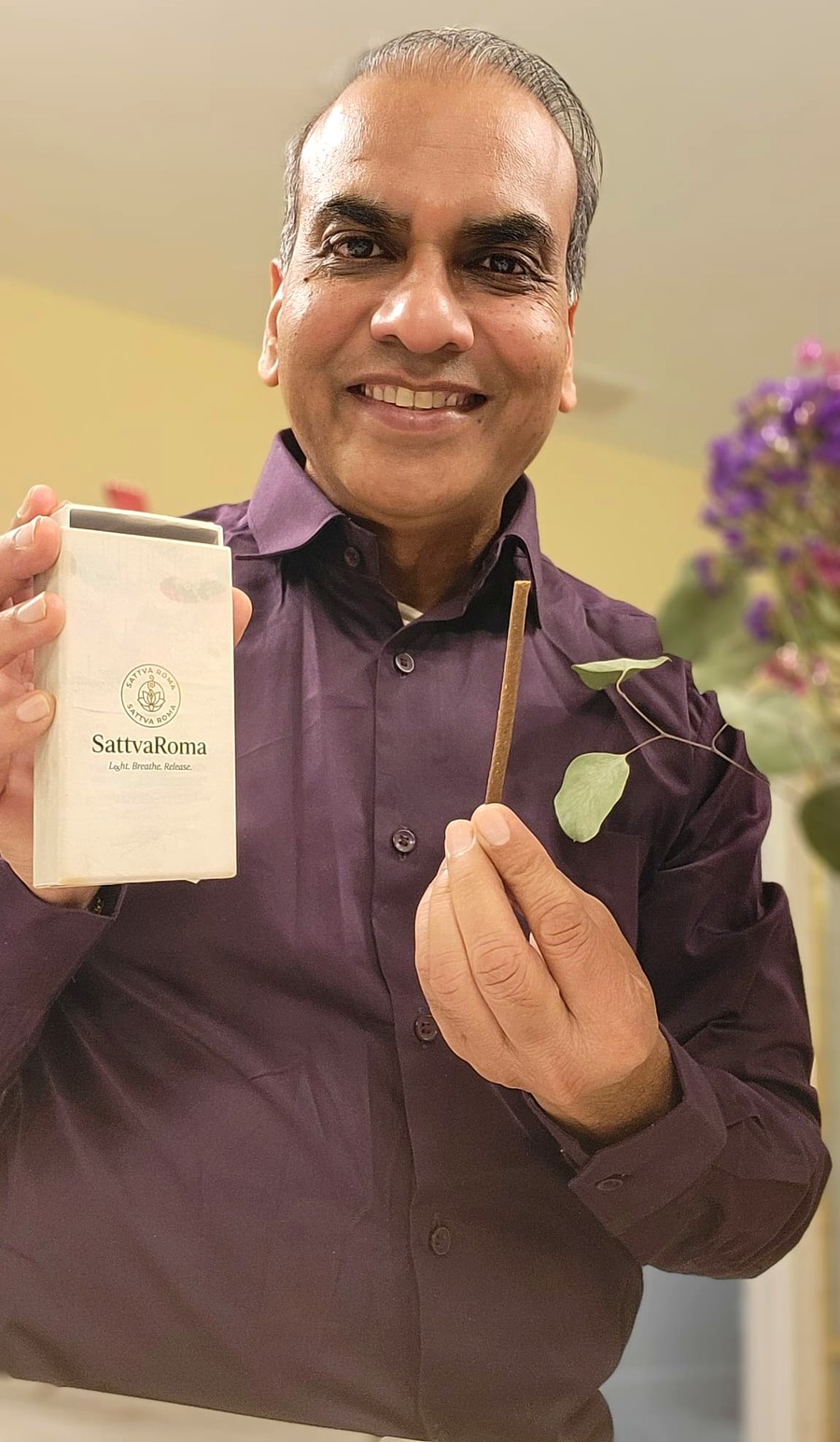 Devi Singh Karnawat (Dev), founder of SattvaRoma, holding a SattvaRoma dhoop box and a charcoal-free dhoop stick